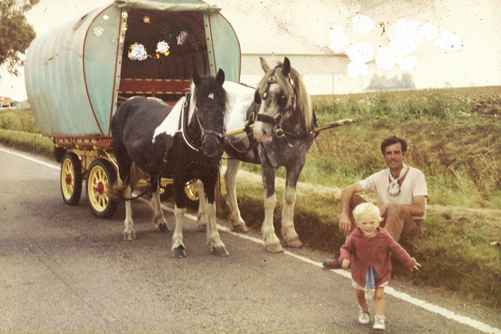 A 1980s family photo: Anastasia Taylor-Lind heads toward her mother, Eleonore Lind, who’s taking the photograph as her father, Bethlehem Taylor, looks on. Horses Star and Blue wait to pull the wagon that was Taylor-Lind’s home.