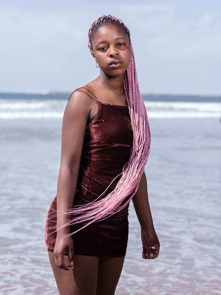 A portrait of a woman with long pink braids