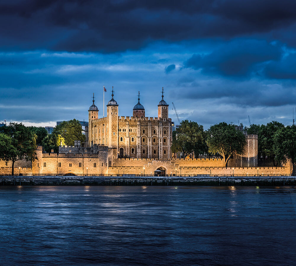 A picture of a large stone building along the water