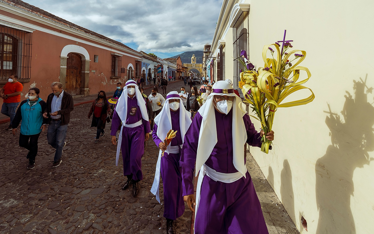 People take part in a procession for Palm Sunday, the start of Holy Week, in the colonial city of Antigua, Guatemala.