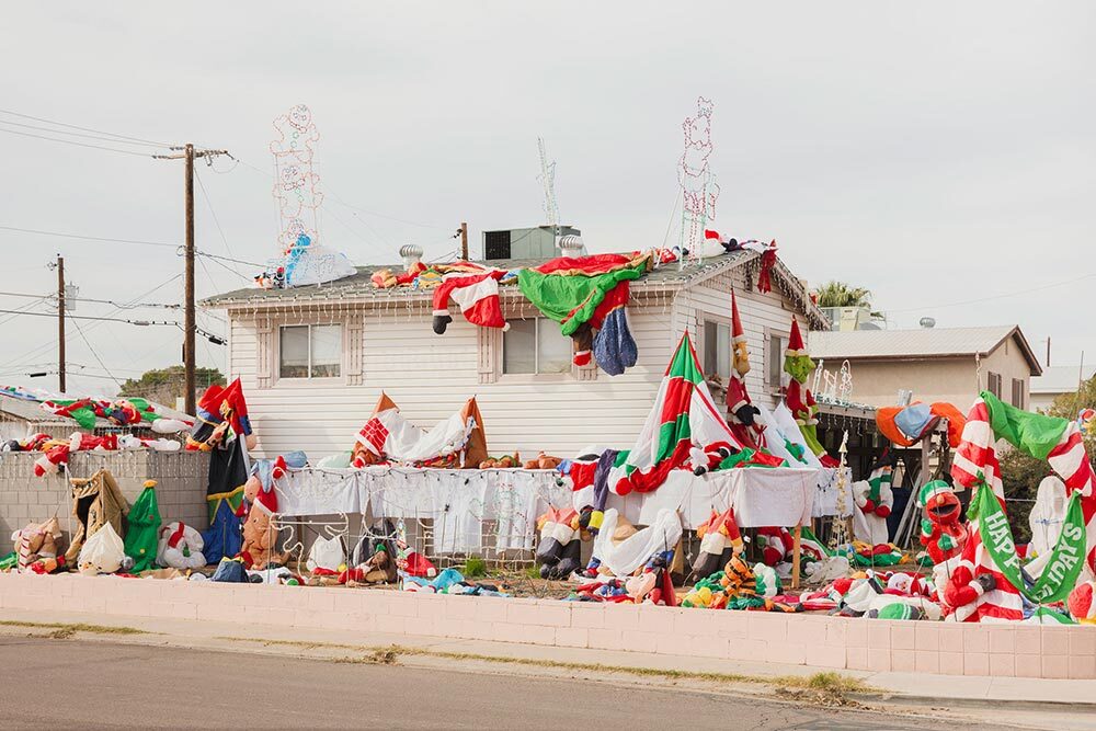 The Tempe, Arizona home of Steve Lanzillo was literally swarmed by inflatable Santas during Christmas season 2017. The displays were not inflated until dusk, when almost as many passersby gathered just to see the limp figures rise awkwardly and come alive. “The density of color when they’re inflated is fascinating, somehow Dali-esque,” Photographer Jesse Rieser says.