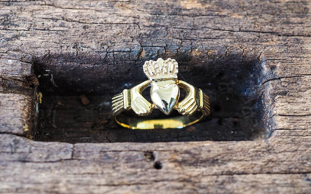 The Claddagh ring design draws on the clasped hands of fede rings, which date back to Roman times.