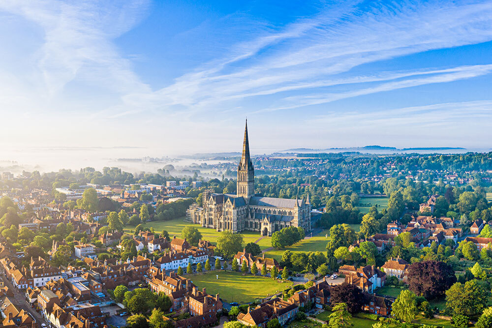 An aerial photograph of a grand cathedral in a town