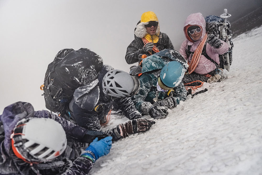 A photo of a climbing team resting before summiting a volcano