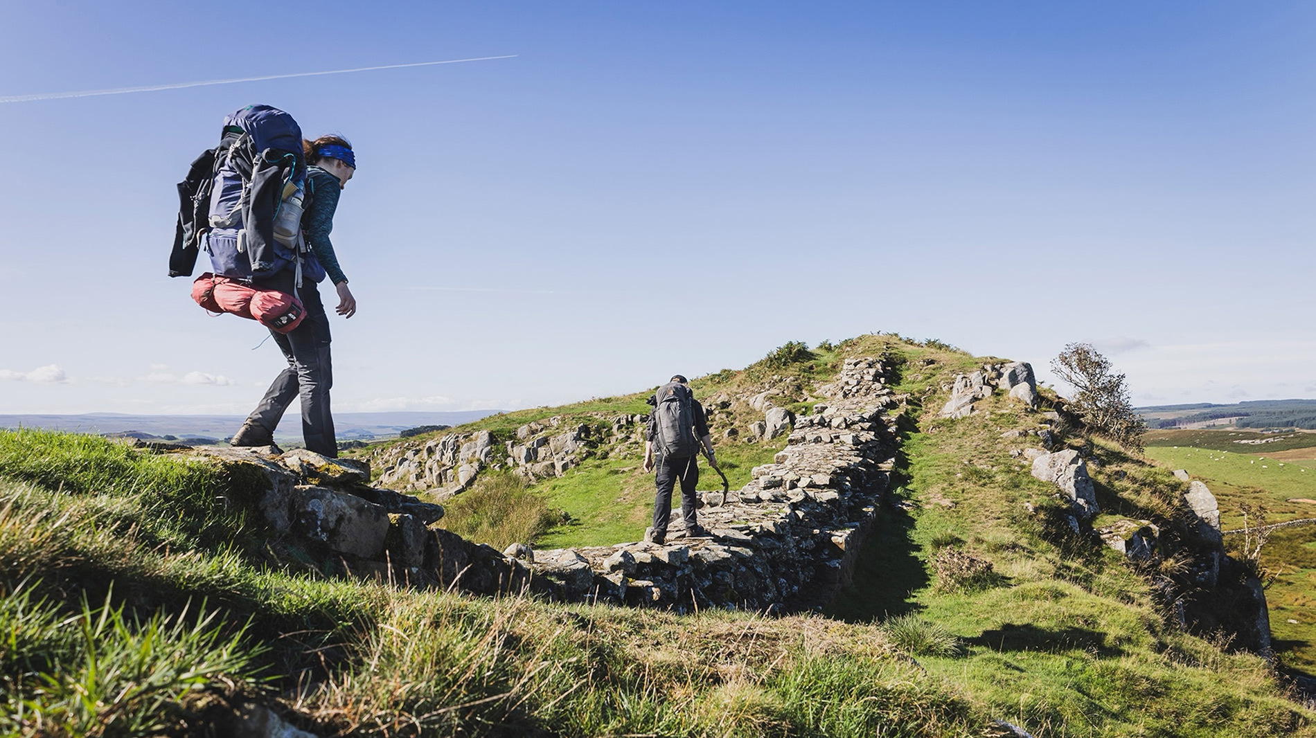 Writer Joe Sills and archaeologist Raven Todd DaSilva traverse a tricky section of Hadrian’s Wall Path, just east of Sewingshields Crags.