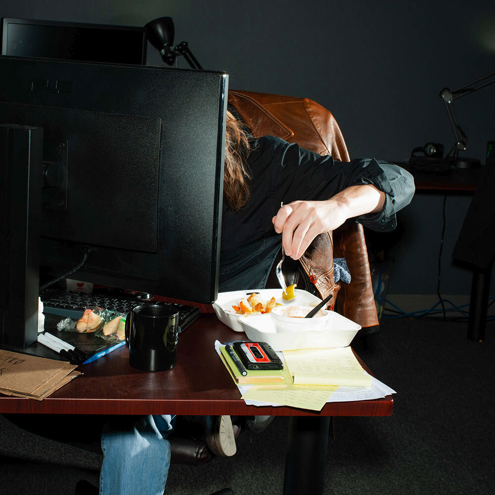 a woman eats at her desk