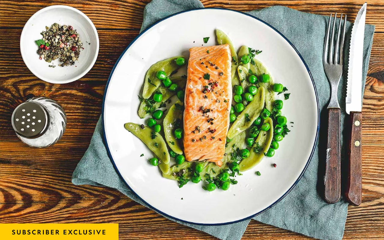 A plate of salmon, pasta, and vegetables