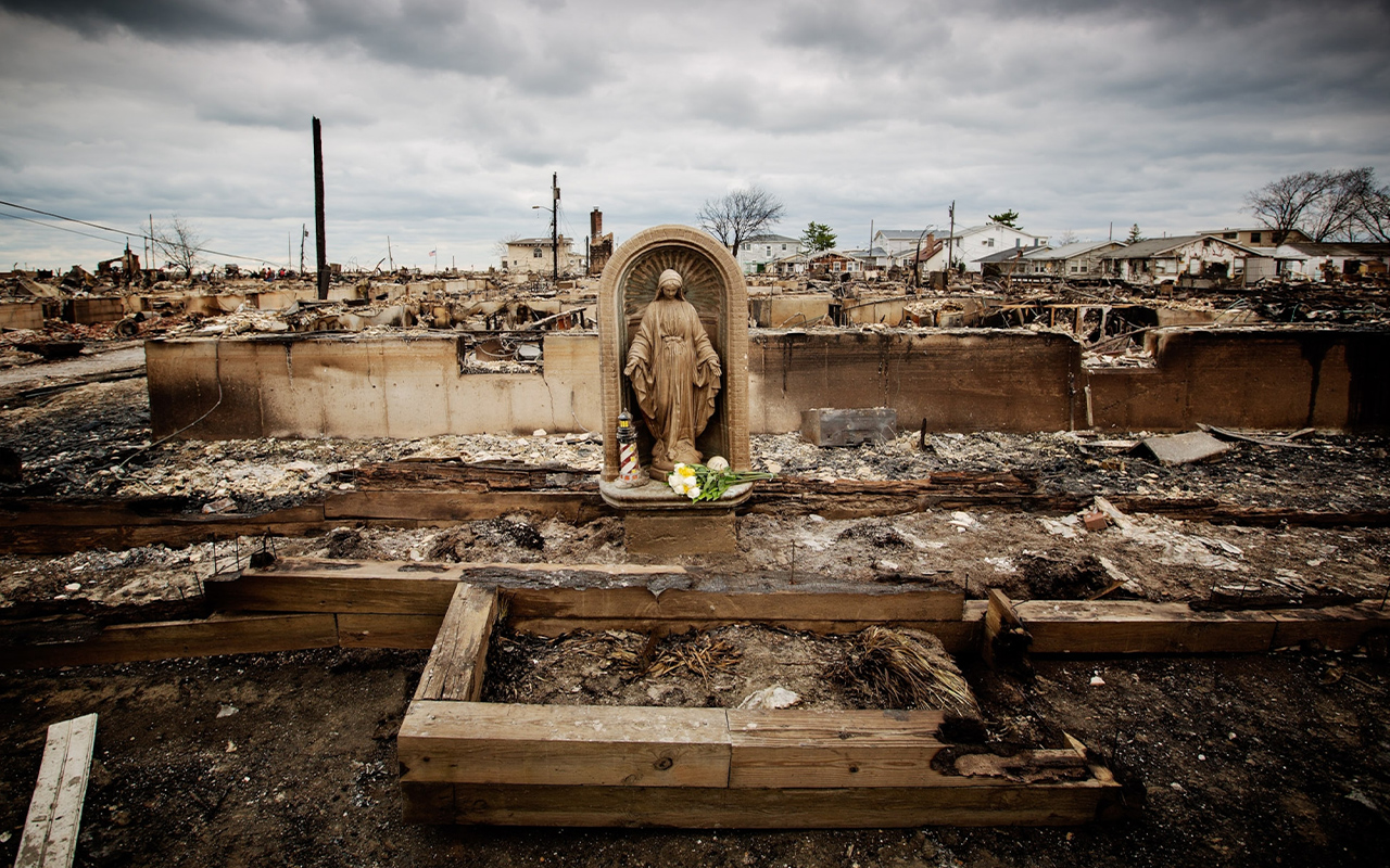 Water, wind, and fire devastated the coastal community of Breezy Point, New York, after Superstorm Sandy toppled electrical lines and sparked fires that destroyed more than 100 homes—but left a statue of the Virgin Mary intact.