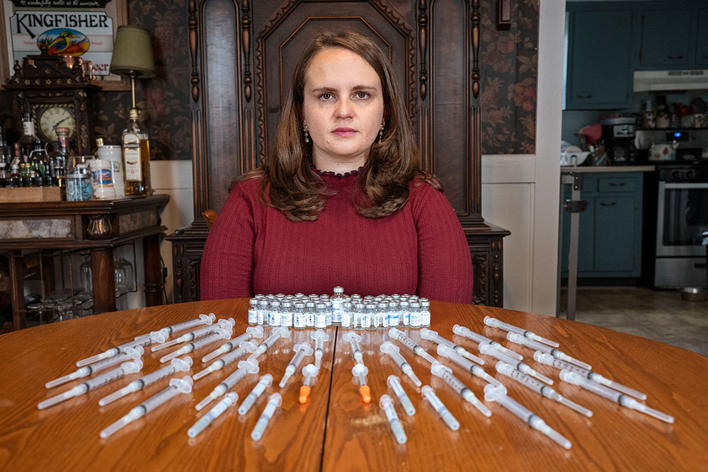 A picture of a woman with many needles laid out in front of her