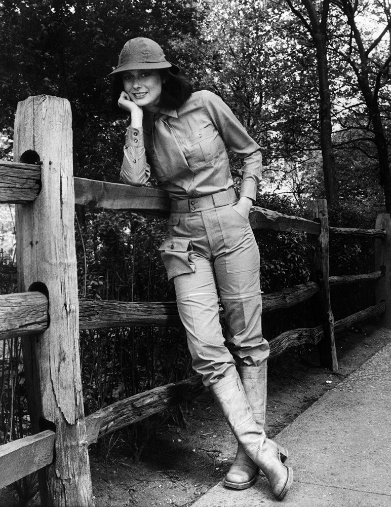 Black and white photo of a woman wearing a safari outfit.