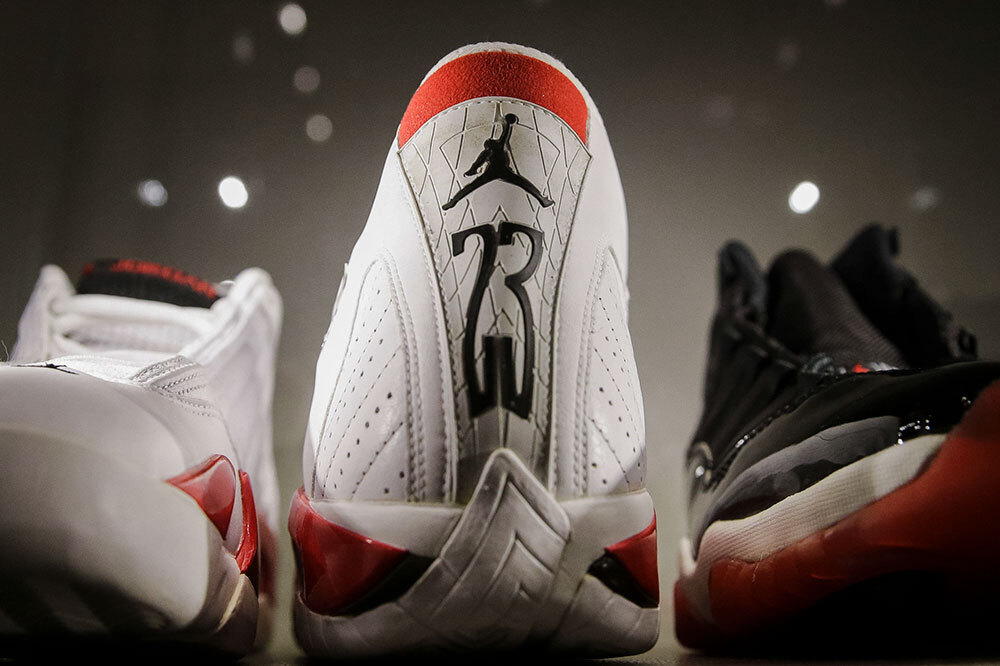 a pair of white sneakers worn by Michael Jordan showing the number 23 on display at an auction