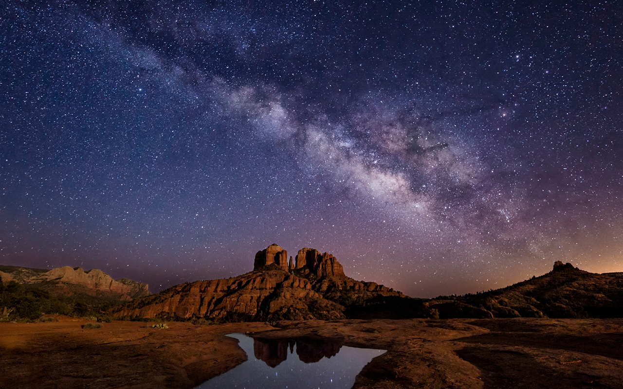 The Milky Way stretches above Cathedral Rock in Sedona, Arizona.