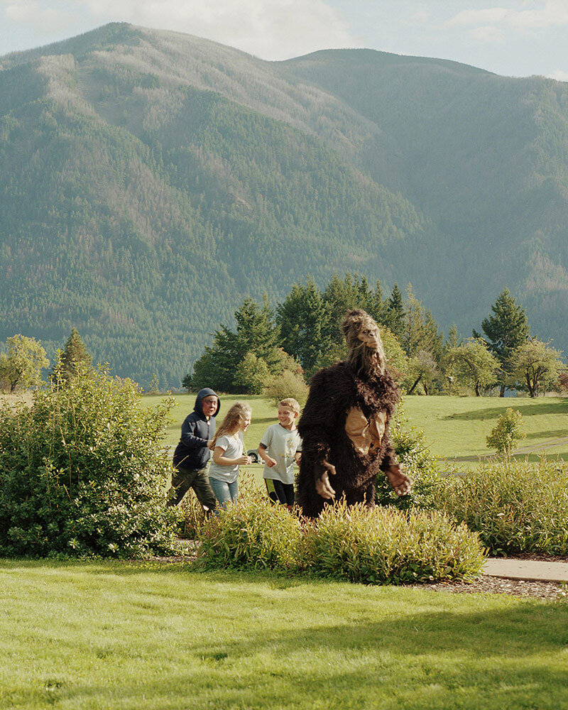 Children chase someone in a Bigfoot costume at a Bigfoot Bash in Home Valley, Washington