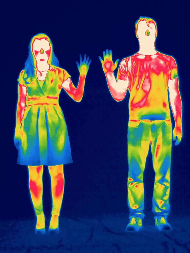 A thermal photo shows a woman's hand cooler than a man's hand.