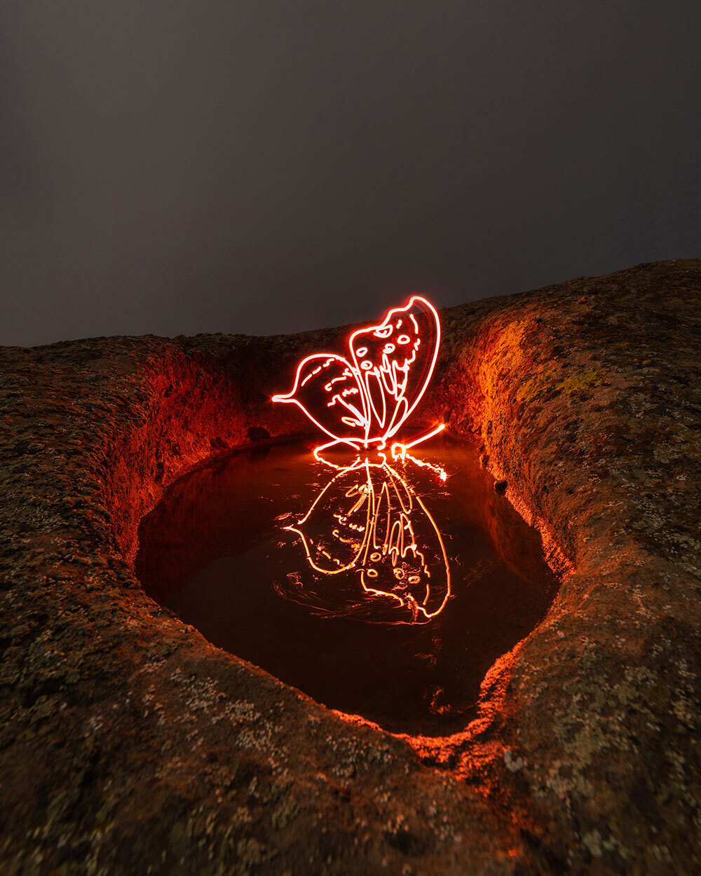 A glowing light drawing of a butterfly