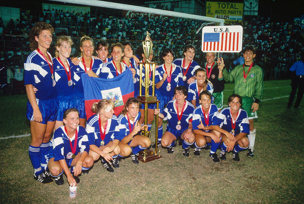 The USA Women’s Soccer team poses after placing first in the 1991 CONCACAF Women’s Soccer Tournament in Haiti. The win qualified the team for the first FIFA Women’s World Cup in China, which they won.