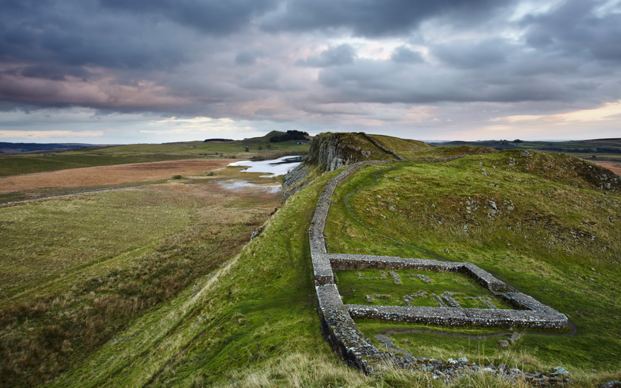 Punctuated with the remains of a milecastle (small fort), Hadrian’s Wall stretches over hilly terrain near Haltwhistle in Northumberland, England.