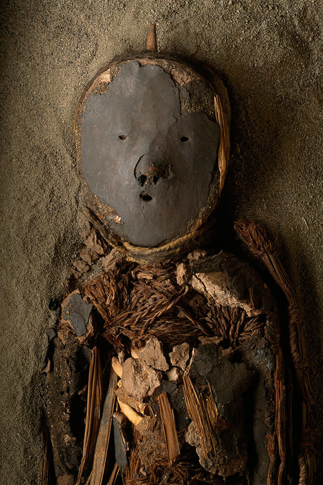 A Chinchorro mummy decorated with a clay mask and pieces of wood