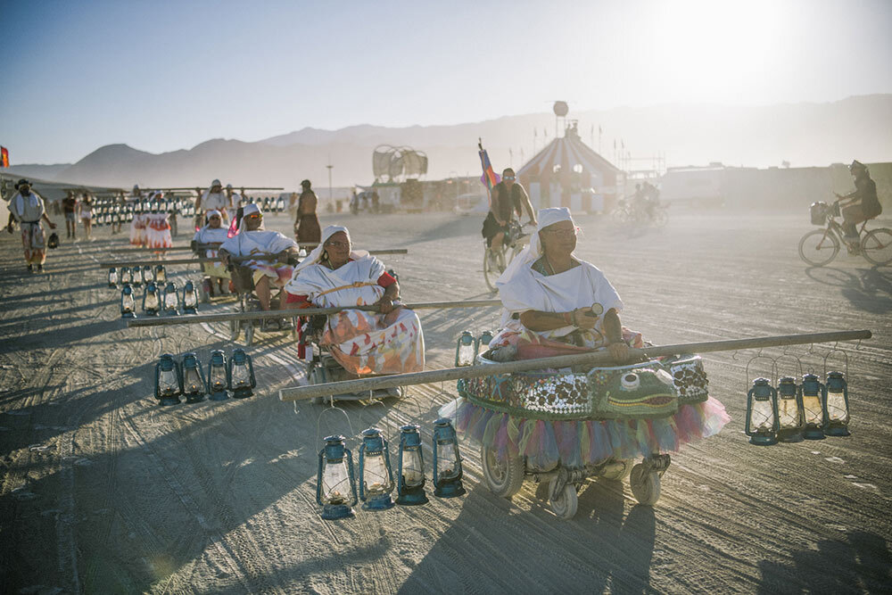 Mobility Camp members serving as “Lamplighters” at Burning Man roll through Black Rock City