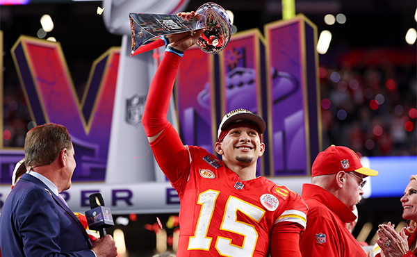 Patrick Mahomes lifts the Vince Lombardi Trophy after winning SBLVIII and SB MVP. 