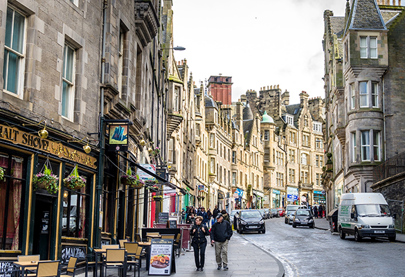 Locals and tourists stroll through Old Town along Cockburn Street, connecting the Royal Mile to Waverley Station.