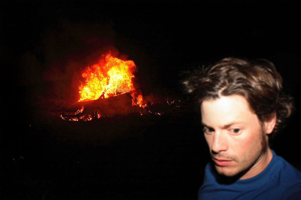 Aaron Huey in front of a burning car