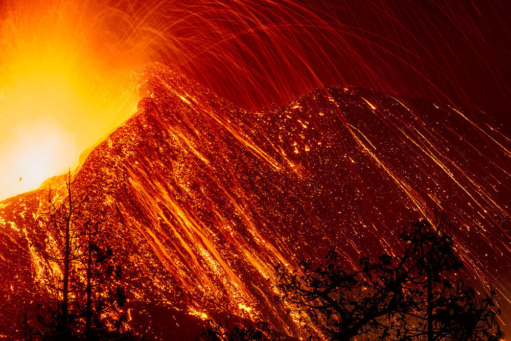 A photo of lava erupting at night