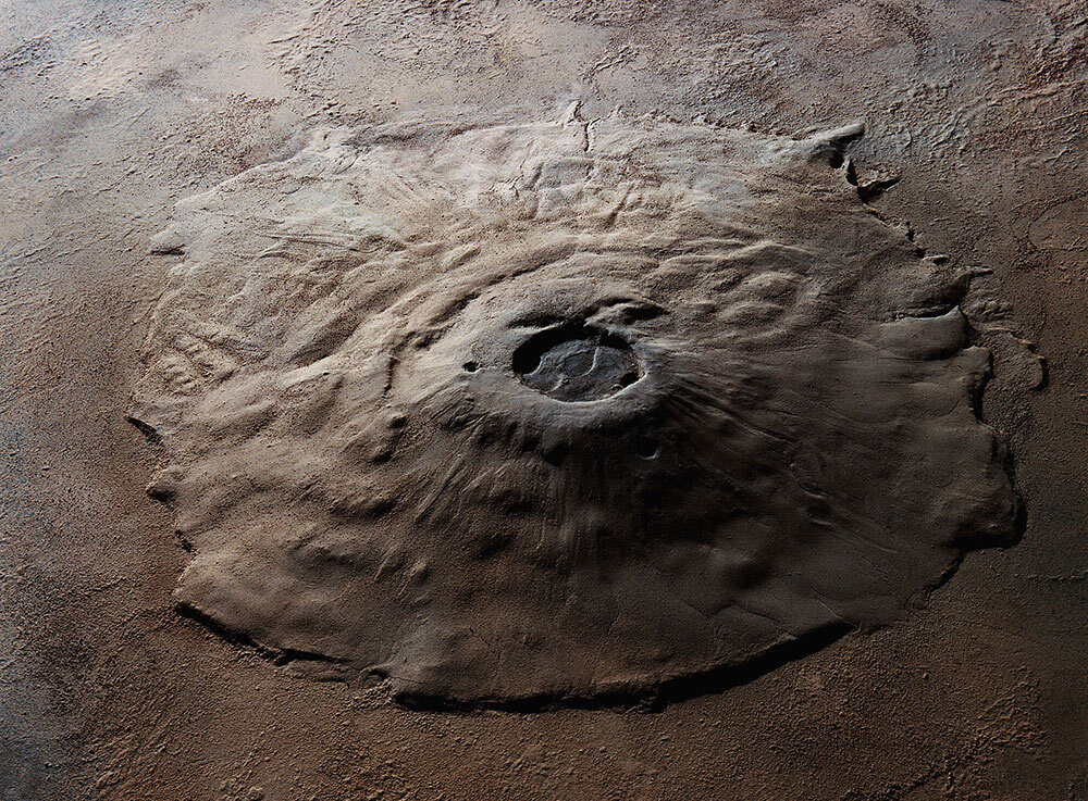 Olympus Mons, the largest known volcano in the solar system, stretches 375 miles across at its base, with walls that tower 15 miles above the plains of Mars.