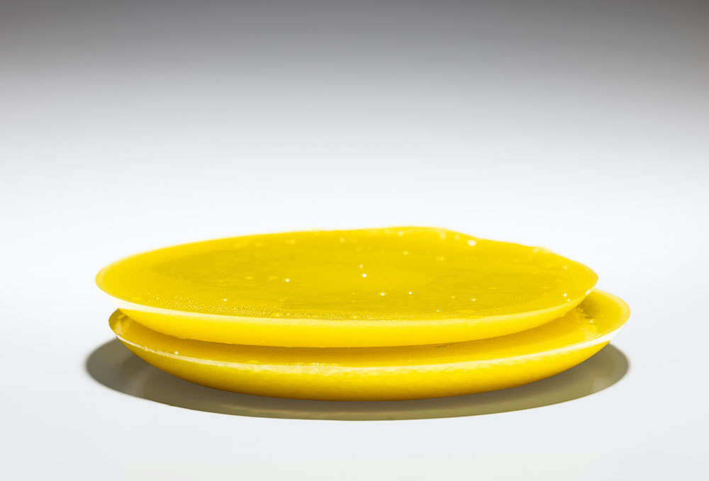 A picture of two yellow disks stacked on top of one another