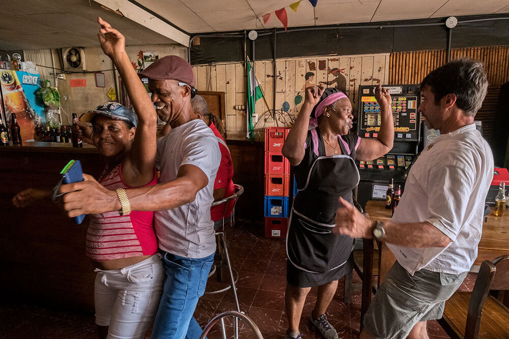 A group of people dance in a bar