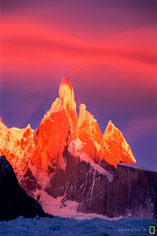 A picture of the sun setting on mountain peaks