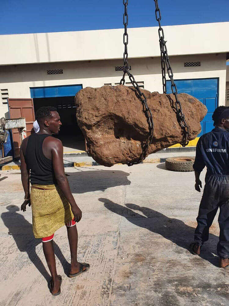 A picture of a large rock being moved