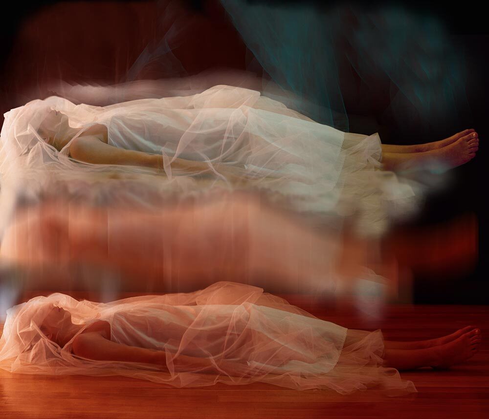 A photo illustration of a sleeping woman floating above herself