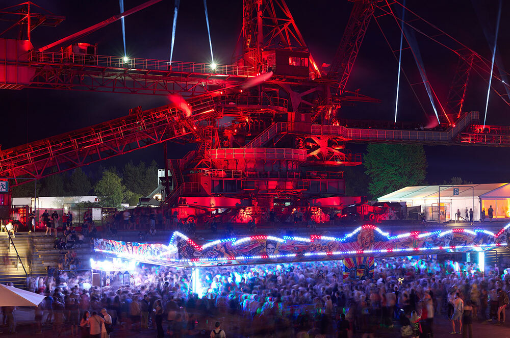 A picture of large industrial equipment looming over a crowd of people