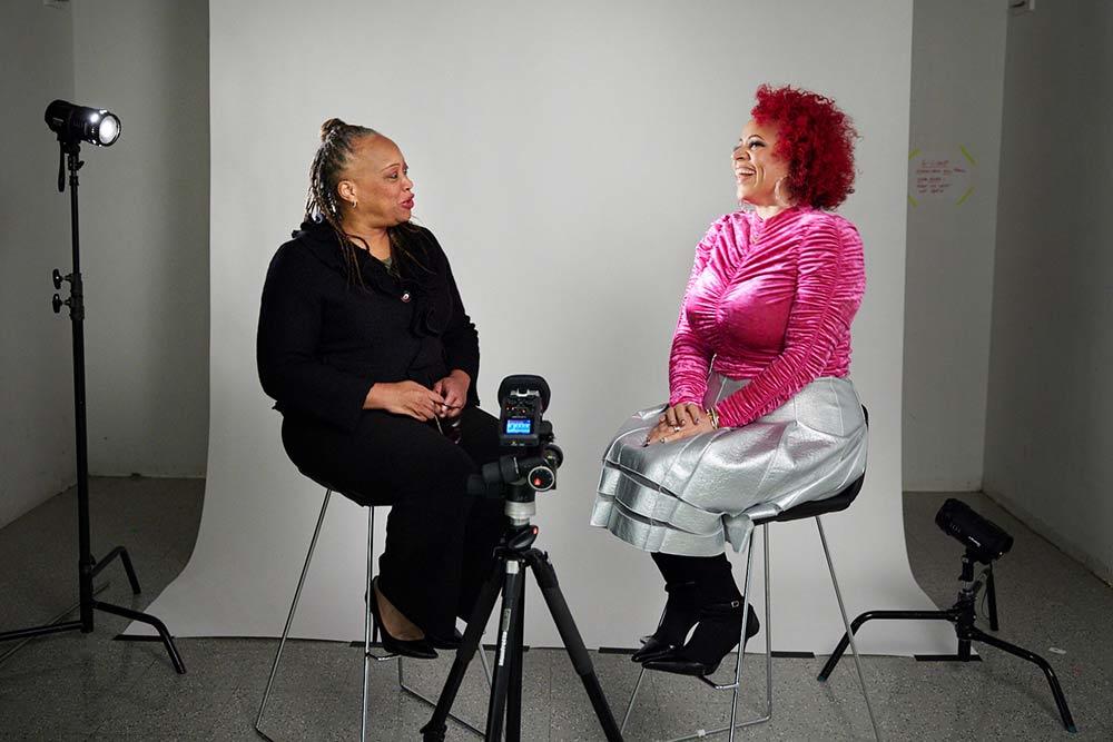 A photo of two women talking to each other