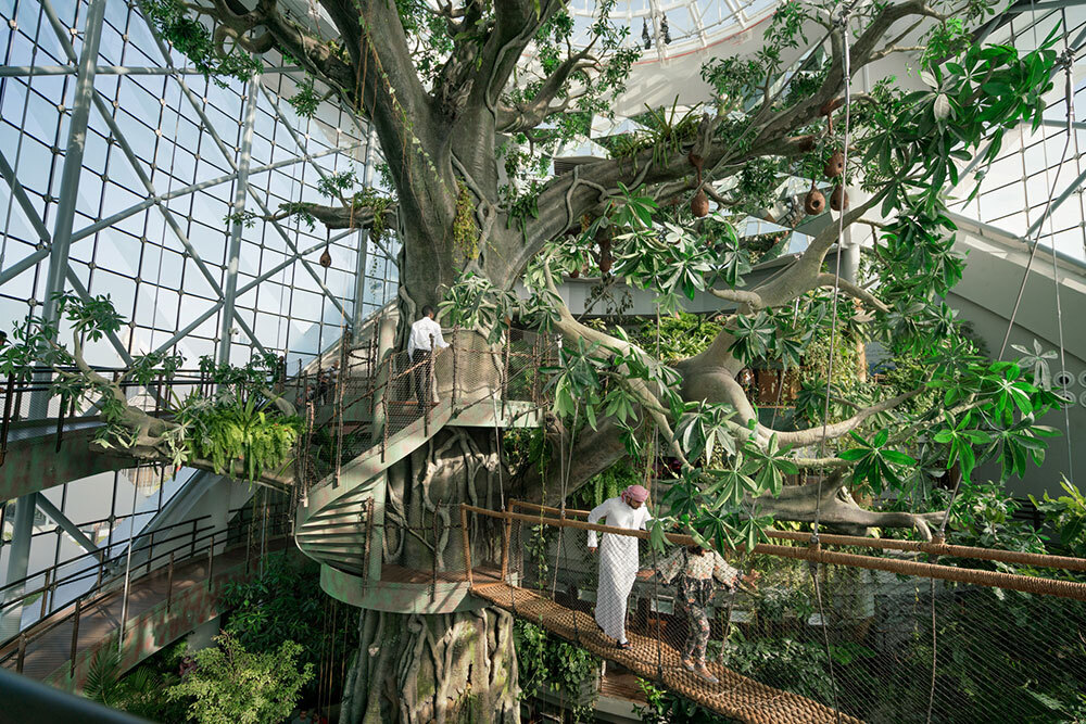 People walk around a tree in Dubai