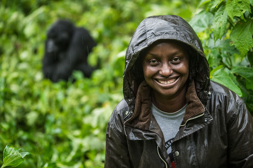 A picture of a woman with an ape in the background