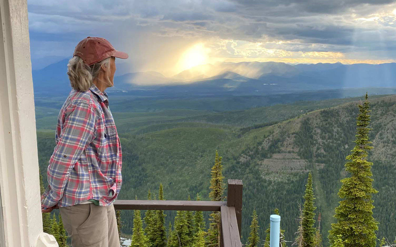 Karen Reeves has worked as a fire lookout in Montana on and off since the 1970s. From a tower at altitude, lookouts have a grand view of a huge swath of forest.