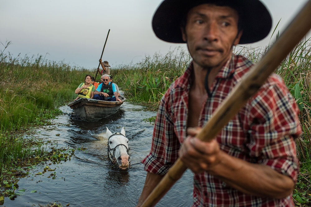 Mingo Avalos poles his canoe through a channel