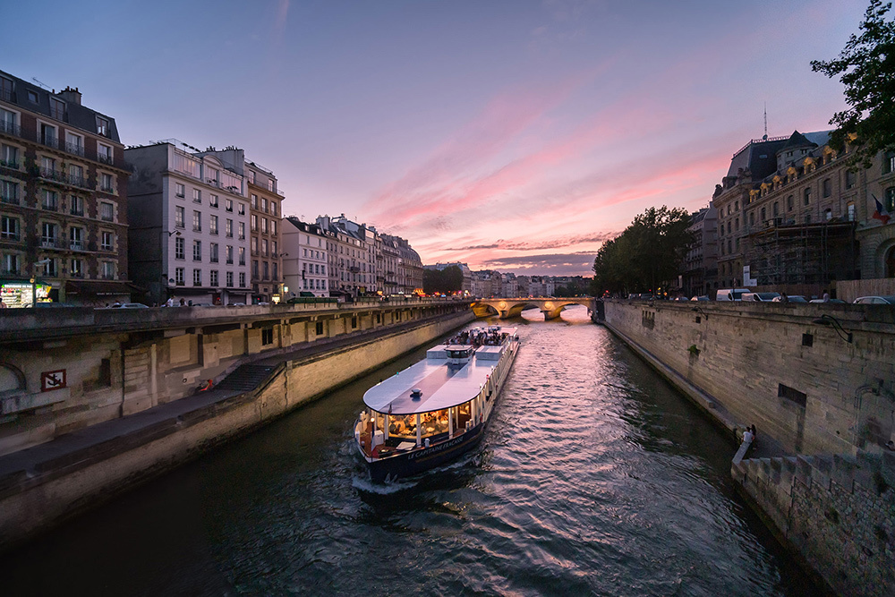 A river cruise floats along the UNESCO-listed banks of the Seine.