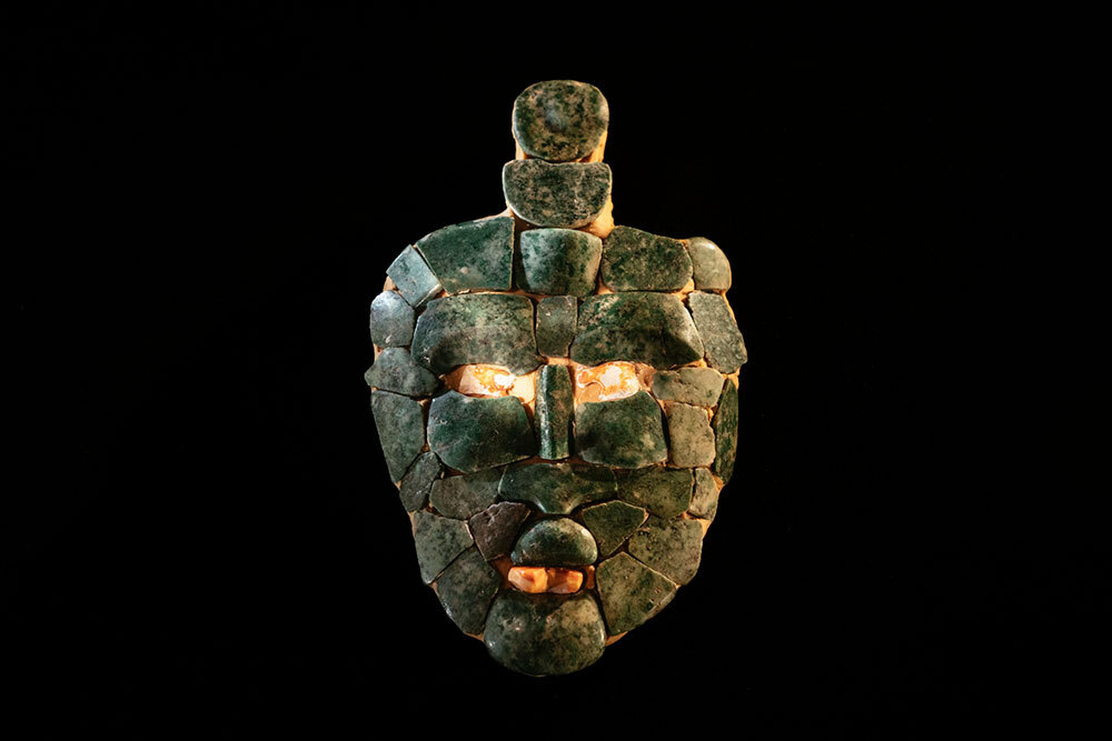 Small mask made of jade mosaic tesserae with spondylus shell tessarae for the eyes and tooth.