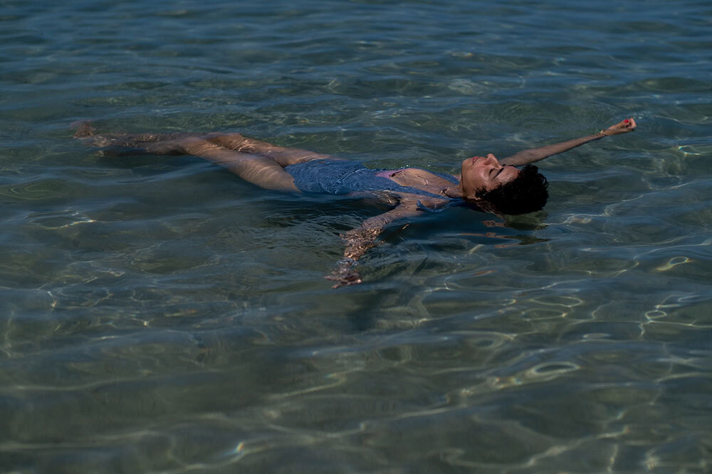 A woman floats in the ocean