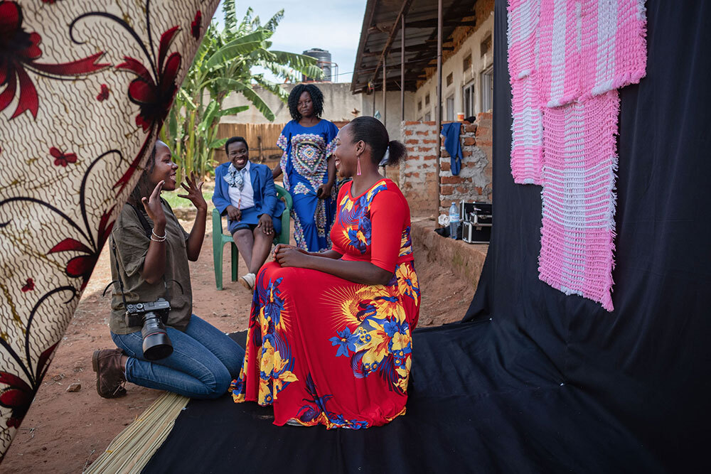 A picture of a photographer talking to a seated model