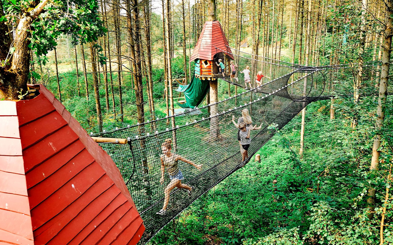 Children walk on suspension bridges at WOW Park in Billund, the first Danish town to be recognized by UNICEF as a Child Friendly City.