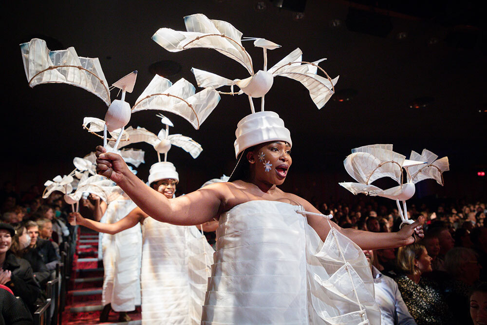 A woman in costume performs in front of an audience