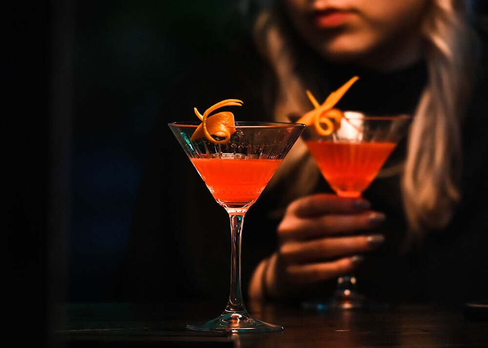 a woman pictured with two martinis