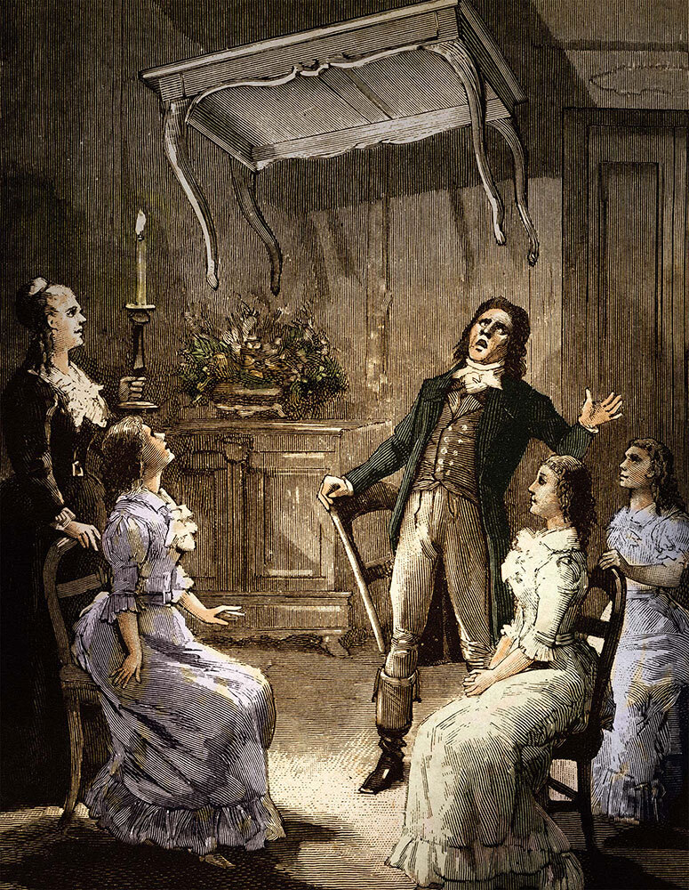 An illustration of a séance with the Fox sisters seated, a table floating, and a man in disbelief