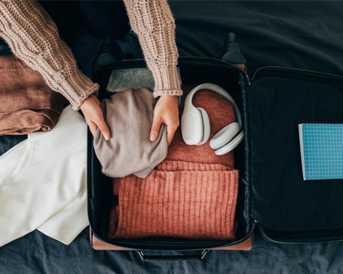 A woman packing her carry-on