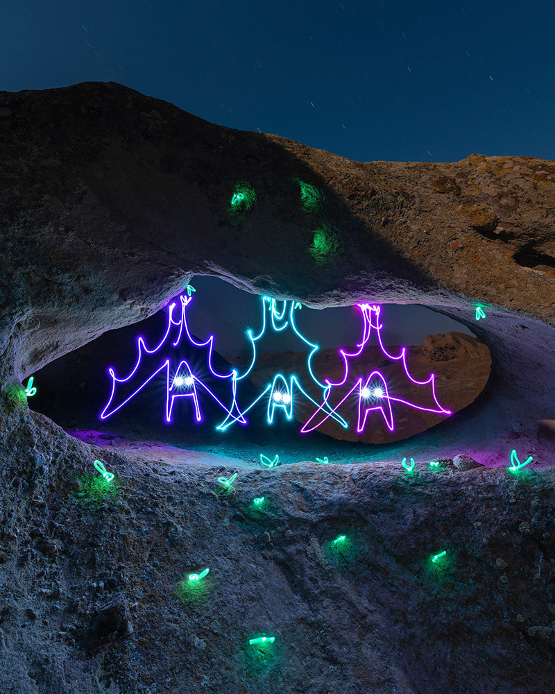 A light painting of bats hanging from rocks