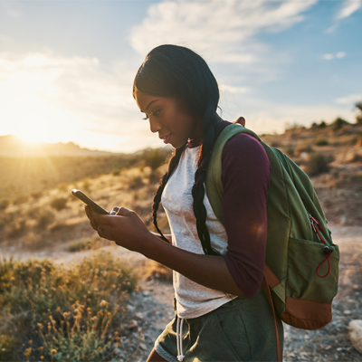 A woman using her cellphone on a trip